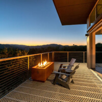 Evening deck setting with fire feature and 6-Hole PERF-O GRIP® Plank Grating flooring.