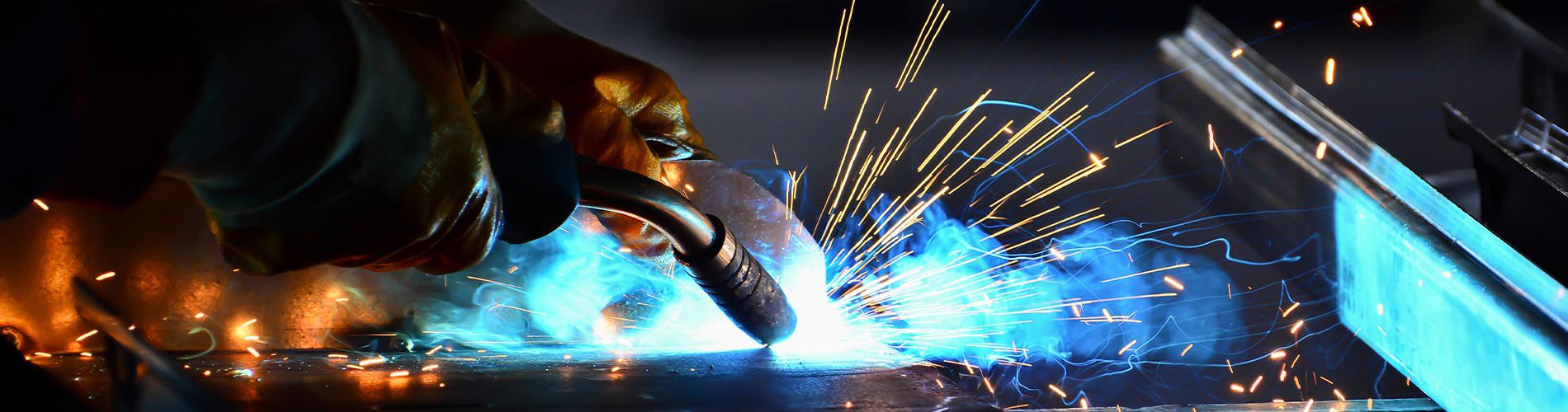 A photo of a welding tool in use, causing sparks to fly.